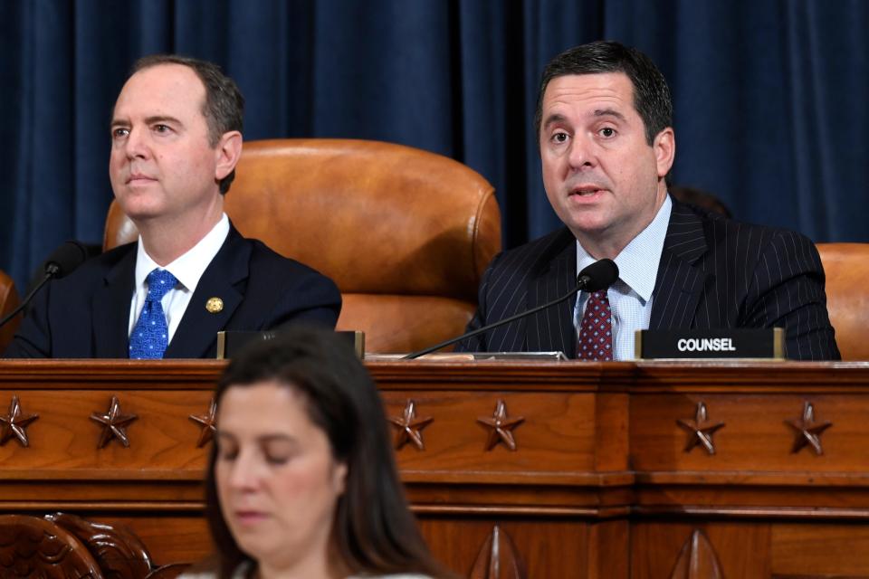 House Intelligence Committee Chairman Adam Schiff, D-Calif., left, listens as ranking member Rep. Devin Nunes of Calif., speaks.