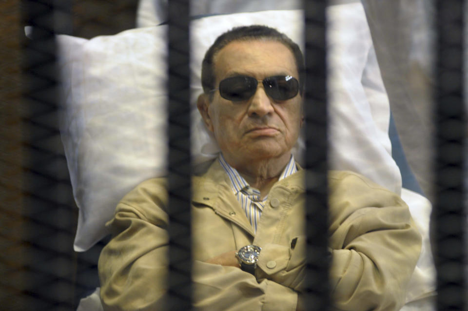 FILE - In this Saturday, June 2, 2012 file photo, Egypt's ex-President Hosni Mubarak lays on a gurney inside a barred cage in the police academy courthouse in Cairo, Egypt. More Arabs are politically engaged than ever before, demanding to be heard. As Egyptians mark the third anniversary of their revolution against autocrat Hosni Mubarak in the name of democracy, there has been a powerful sign of the country’s stunning reversals since: letters of despair by some of the prominent activists who helped lead the uprising, leaked from the prisons where they are now jailed. The letters show a daunted and broken spirit, no longer speaking of imminent democracy, but of injustices and a failed struggle.(AP Photo, File)