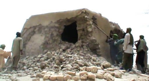 A still from a video shows Islamist militants destroying an ancient shrine in Timbuktu on July 1. Islamist rebels smashed the entrance of a 15th-century Timbuktu mosque on Monday, while their Al-Qaeda allies in northern Mali cut off the key city of Gao by planting landmines all around it