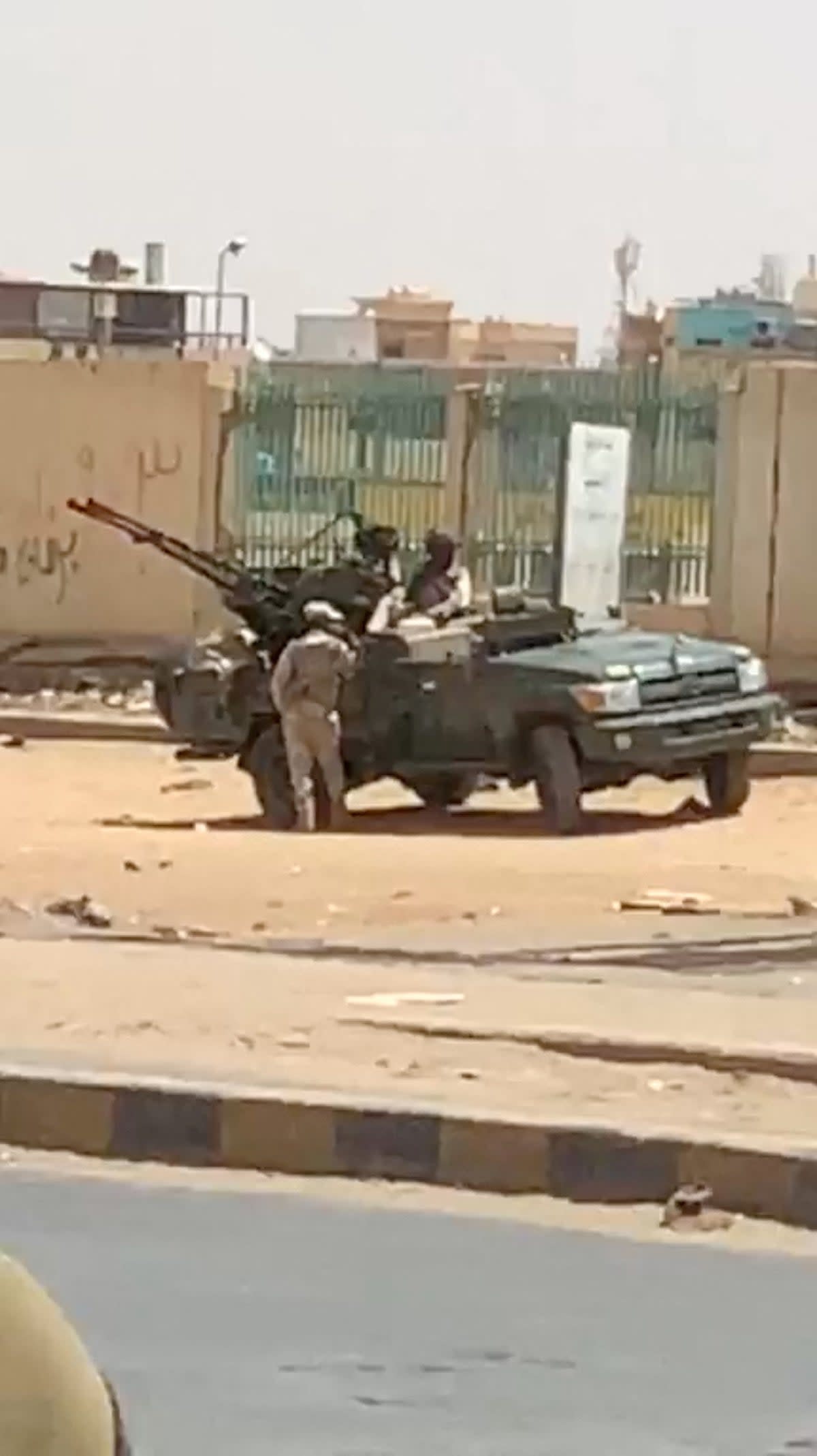 A military vehicle and soldiers are seen on a street of Khartoum (Reuters)