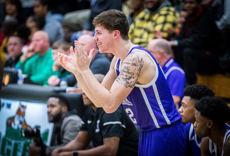 Muncie Central basketball player Dylan Stafford claps from the bench during a game at Yorktown High School on Nov. 30, 2019.