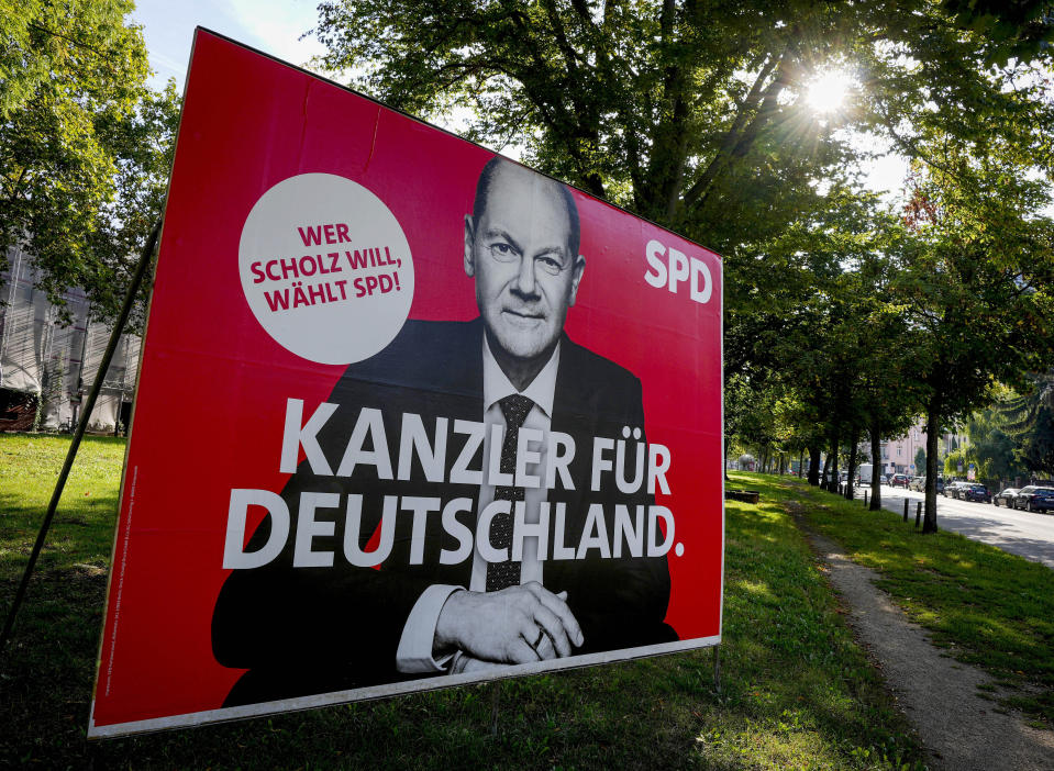 An election poster shows Social Democratic top candidate for chancellor Olaf Scholz in Frankfurt, Germany, Monday, Sept. 13, 2021. German elections will be on Sept.26. Letters read "Chancellor for Germany - Whoever wants Scholz votes the SPD". (AP Photo/Michael Probst)
