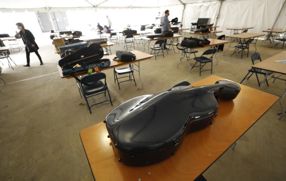 Musical instruments sit on spaced-apart folding tables