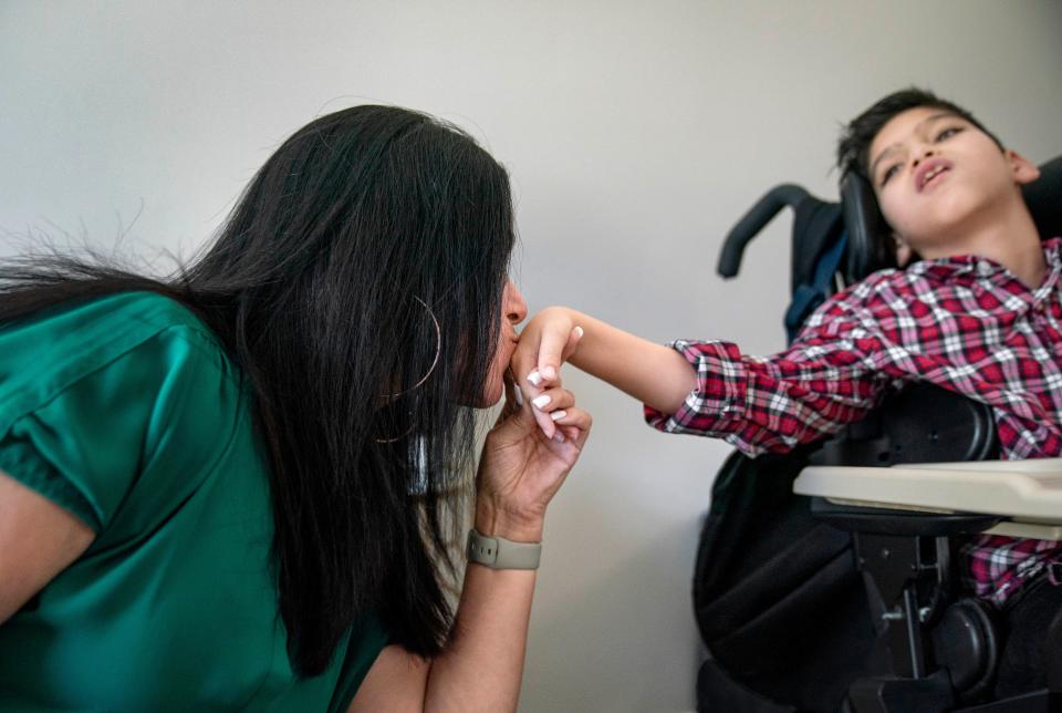 Nicole and her son Liam, 11,  are rarely apart. They share hugs and kisses.  Liam also communicates with an iPad at school and a notebook of images at home.