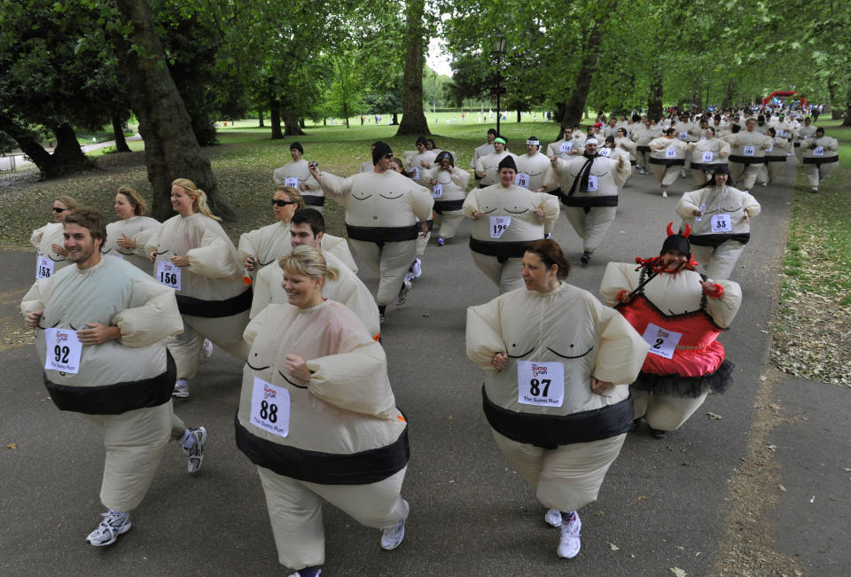 Runners dressed in inflatable Sumo costumes take part in a charity 5km (3 miles) run at Battersea Park in London June 19, 2010. Organisers claimed a new world record for a mass Sumo suit gathering at the annual event. REUTERS/Toby Melville