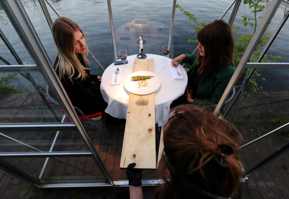 Waiters wear gloves and transparent face shields and use a longboard (Picture: Reuters)