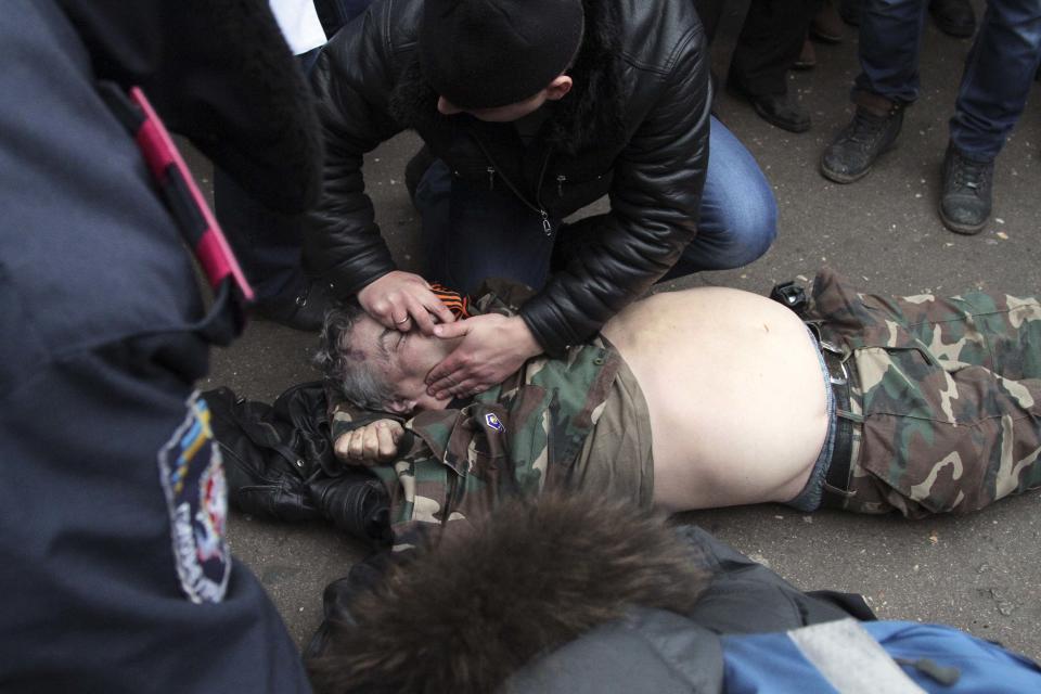 A man receives medical treatment after he was injured in clashes during rallies held by ethnic Russians and Crimean Tatars in Simferopol