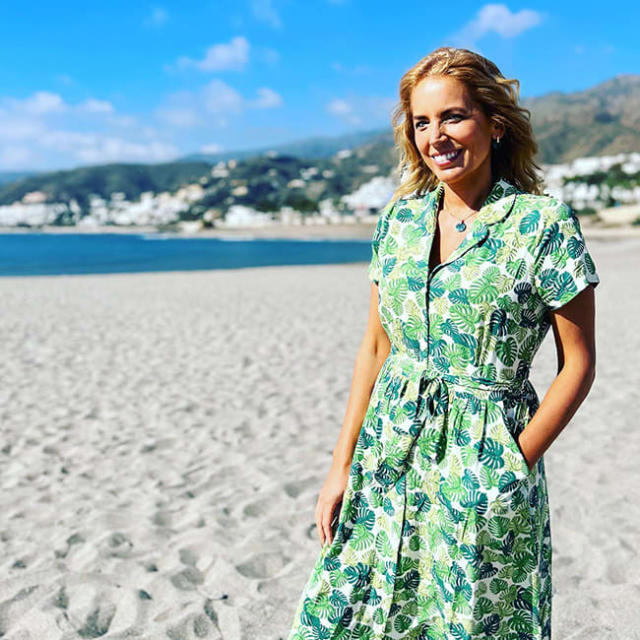Jasmine Harman wearing a green dress whilst posing in a beach