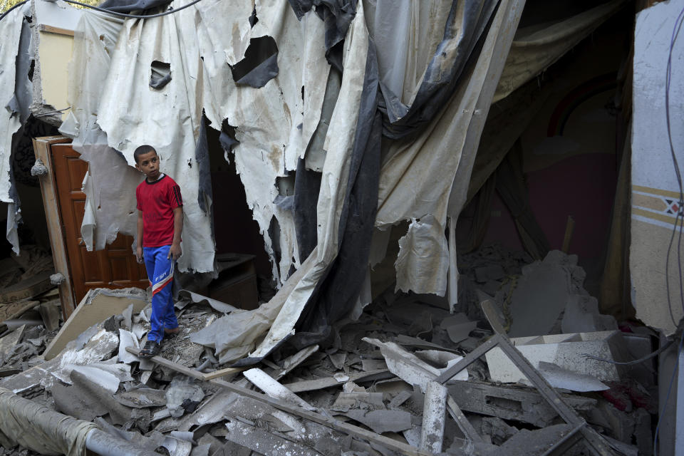 FILE - Mohammad Arada looks at the rubble of his family house after it was destroyed by an Israeli airstrike, in Rafah refugee camp, southern Gaza Strip, Monday, Aug. 8, 2022. The death toll from last weekend's fighting between Israel and Gaza militants has risen to 47, after a man died from wounds sustained during the violence, the Health Ministry in Gaza said Thursday, Aug. 11, 2022. (AP Photo/Adel Hana, File)