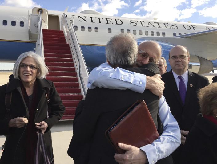 CLICK IMAGE for slideshow: Alan Gross embraces Tim Rieser (C, back to camera), a member of Senator Patrick Leahy&#39;s office, on the tarmac as he disembarks from a U.S. government plane with wife Judy (L) at Joint Base Andrews in Maryland outside Washington December 17, 2014 in this photo courtesy of Jill Zuckman. The United States plans to restore diplomatic relations with Cuba more than 50 years after they were severed, a major policy shift after decades of hostile ties with the communist-ruled island, President Barack Obama said on Wednesday. Obama discussed the changes with Cuban President Raul Castro on Tuesday in a telephone call that lasted nearly an hour. Castro spoke in Cuba as Obama made his announcement on a policy shift made possible by the release of American Alan Gross, 65, who had been imprisoned in Cuba for five years. REUTERS/Jill Zuckman/Gross Family spokesperson/Handout via Reuters (UNITED STATES - Tags: POLITICS) ATTENTION EDITORS - THIS PICTURE WAS PROVIDED BY A THIRD PARTY. REUTERS IS UNABLE TO INDEPENDENTLY VERIFY THE AUTHENTICITY, CONTENT, LOCATION OR DATE OF THIS IMAGE. FOR EDITORIAL USE ONLY. NOT FOR SALE FOR MARKETING OR ADVERTISING CAMPAIGNS. NO SALES. NO ARCHIVES. THIS PICTURE WAS PROCESSED BY REUTERS TO ENHANCE QUALITY. AN UNPROCESSED VERSION WILL BE PROVIDED SEPARATELY