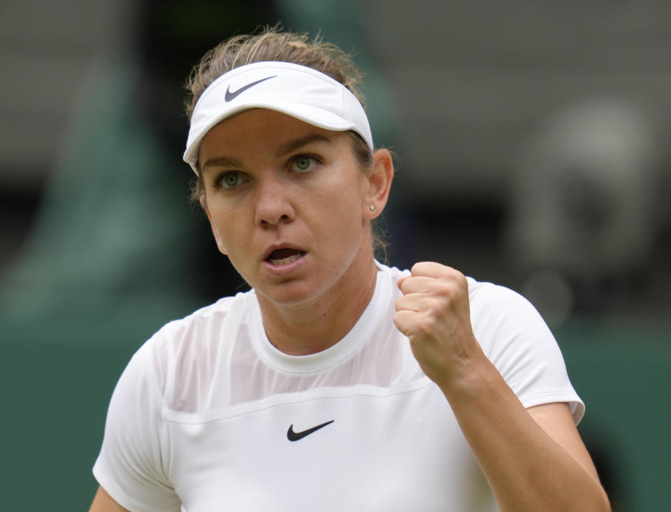 FILE - Romania's Simona Halep reacts as she plays Amanda Anisimova, of the United States, in a women's singles quarterfinal match on the tenth day of the Wimbledon tennis championships in London, July 6, 2022. Two-time Grand Slam champion Halep has been accused of a second doping offense by the International Tennis Integrity Agency for irregularities in her Athlete Biological Passport. The charge announced Friday, May 19, 2023, “is separate and in addition to” the provisional suspension Halep received last year after failing a drug test during the U.S. Open in August, the ITIA said. (AP Photo/Kirsty Wigglesworth, File)