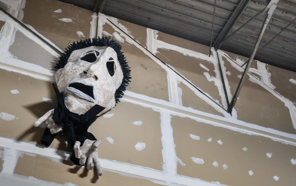 One of Adam Carlson's puppets created for "The Revolutionists" in 2022 hangs in the storage area at Riverwalk Theatre in Lansing, seen Weldnesday, May 15, 2024.