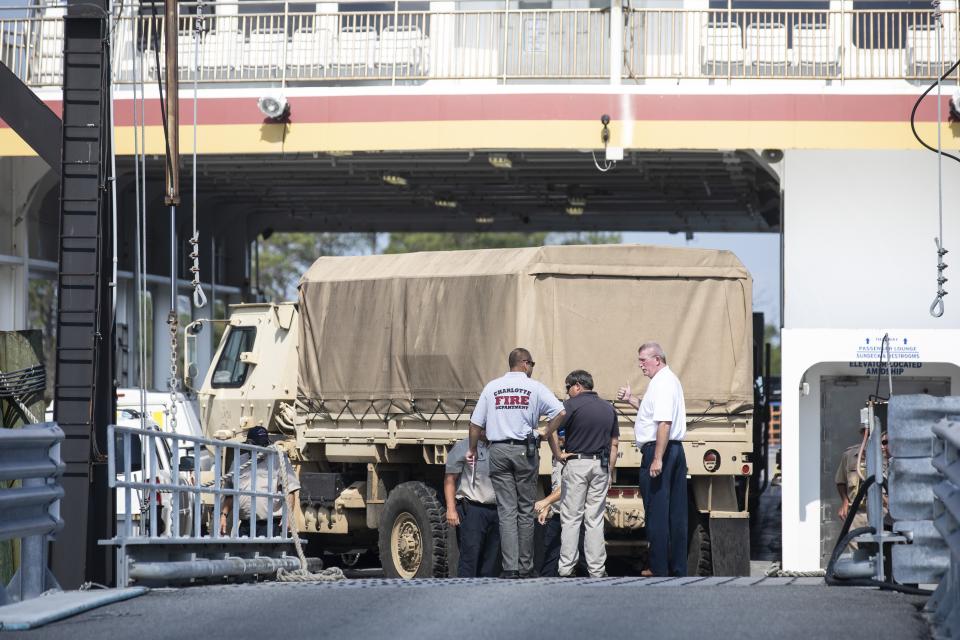 An N.C. National Guard truck is loaded onto the Swan Quarter Ferry in Swan Quarter, N.C on Saturday, Sept. 7, 2019. Several ferries from around the area will be running supplies to Ocracoke, NC, which was devastated by Hurricane Dorian. (Julia Wall/The News & Observer via AP)