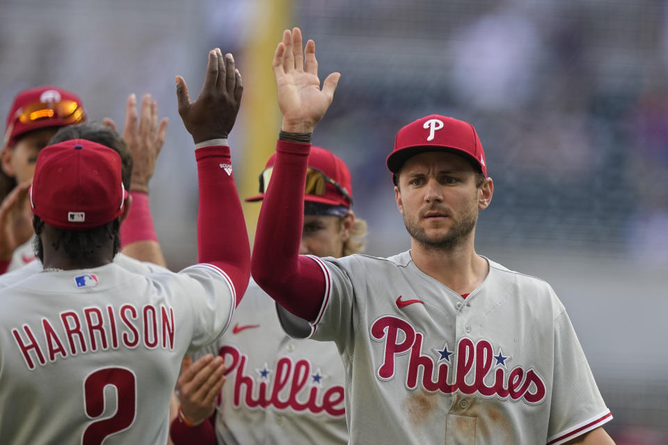 Philadelphia Phillies' Trea Turner (7) high fives teammates after their win against the Atlanta Braves, Saturday, May 27, 2023, in Atlanta. (AP Photo/Brynn Anderson)