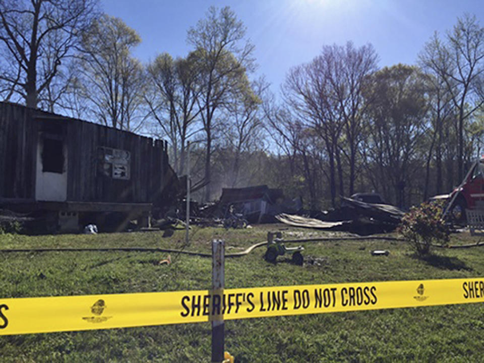 This photo provided by Cassie Walsh, of WMFU Radio, shows the remains of a house that caught fire killing five family members in the early morning hours Friday, April 7, 2017, in Buchanan, Tenn. A young teenager saved her little sister's life in the overnight house fire that killed their parents and three siblings, a Tennessee sheriff said Friday. (Cassie Walsh/WMUF Radio via AP)