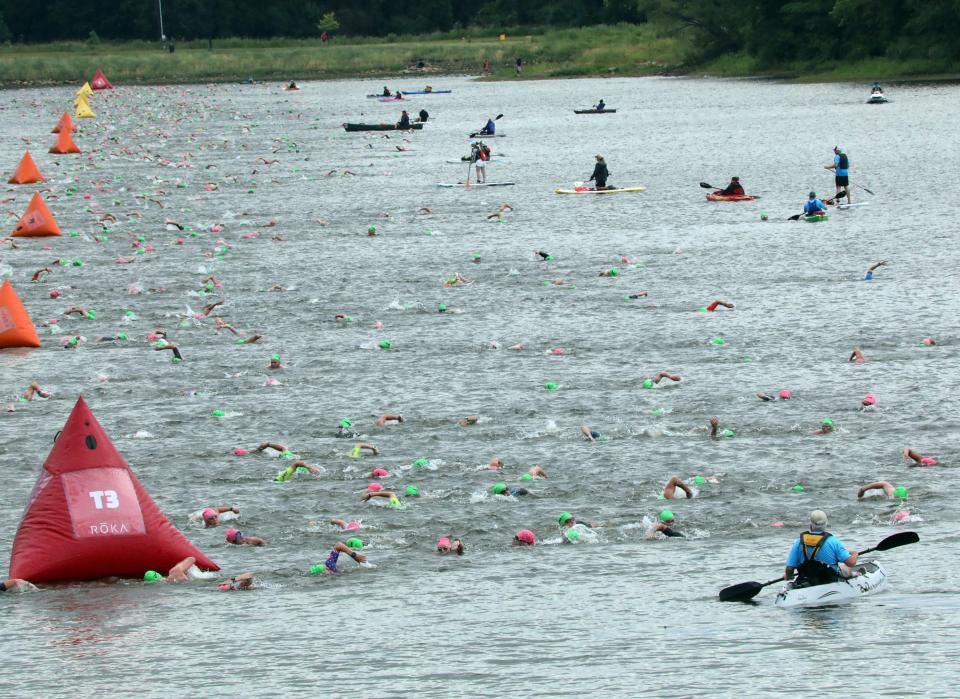 Swimmers compete during the inaugural edition of the Ironman 70.3 mile Des Moines Triathlon as athletes compete in a 1.2-mile swim at Gray’s Lake, 56.0 mile bike race (shortened due to 3-hour rain delay), and a 13.1 mile run in Des Moines.