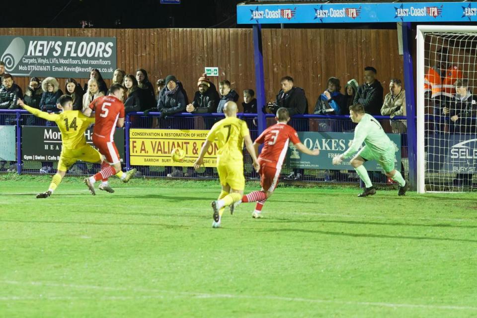 Jamie McGrath (yellow shirt, No.14) turns home a cross for Needham Market’s second goal against Felixstowe & Walton United. Image: PAUL VOLLER <i>(Image: Paul Voller)</i>