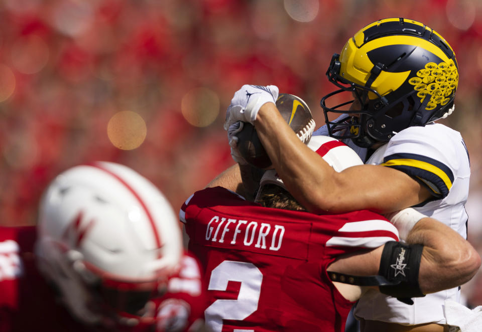 Michigan's Roman Wilson, right, catches a touchdown pass against the helmet of Nebraska's Isaac Gifford during the first half of an NCAA college football game Saturday, Sept. 30, 2023, in Lincoln, Neb. (AP Photo/Rebecca S. Gratz)
