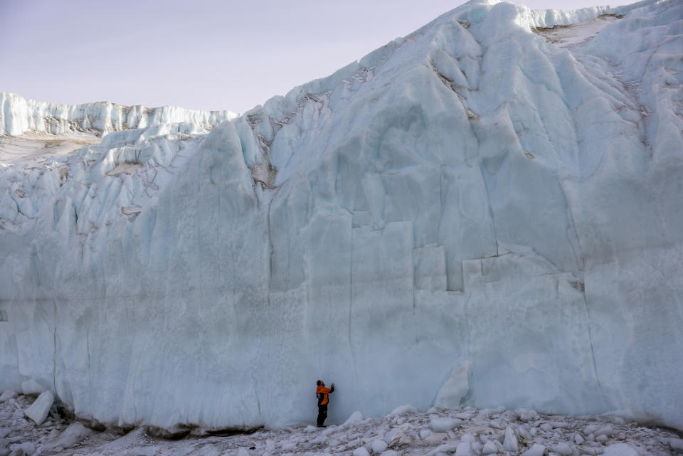 Shayne Misselbrook stands in front of a glacier in the Taylor Valley in Antarctica, Thursday, Oct. 27, 2022. (Mike Scott/NZ Herald via AP, Pool)