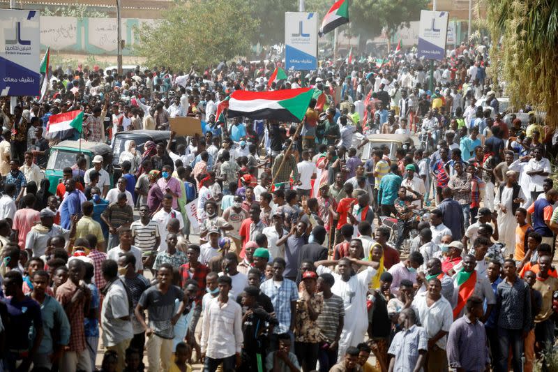 Civilians gather as members of Sudanese pro-democracy protest on the anniversary of a major anti-military protest, as groups loyal to toppled leader Omar al-Bashir plan rival demonstrations in Khartoum