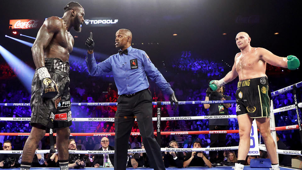 Referee Kenny Bayless, pictured here speaking to Deontay Wilder during his heavyweight bout against Tyson Fury.