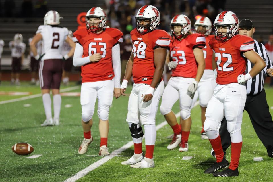 Monroe defenders Roman Beck (63), Breylon Richards (68), Chase Reaume (53) and Angel Rincon look for the call during a 52-13 loss to Dexter Friday night.
