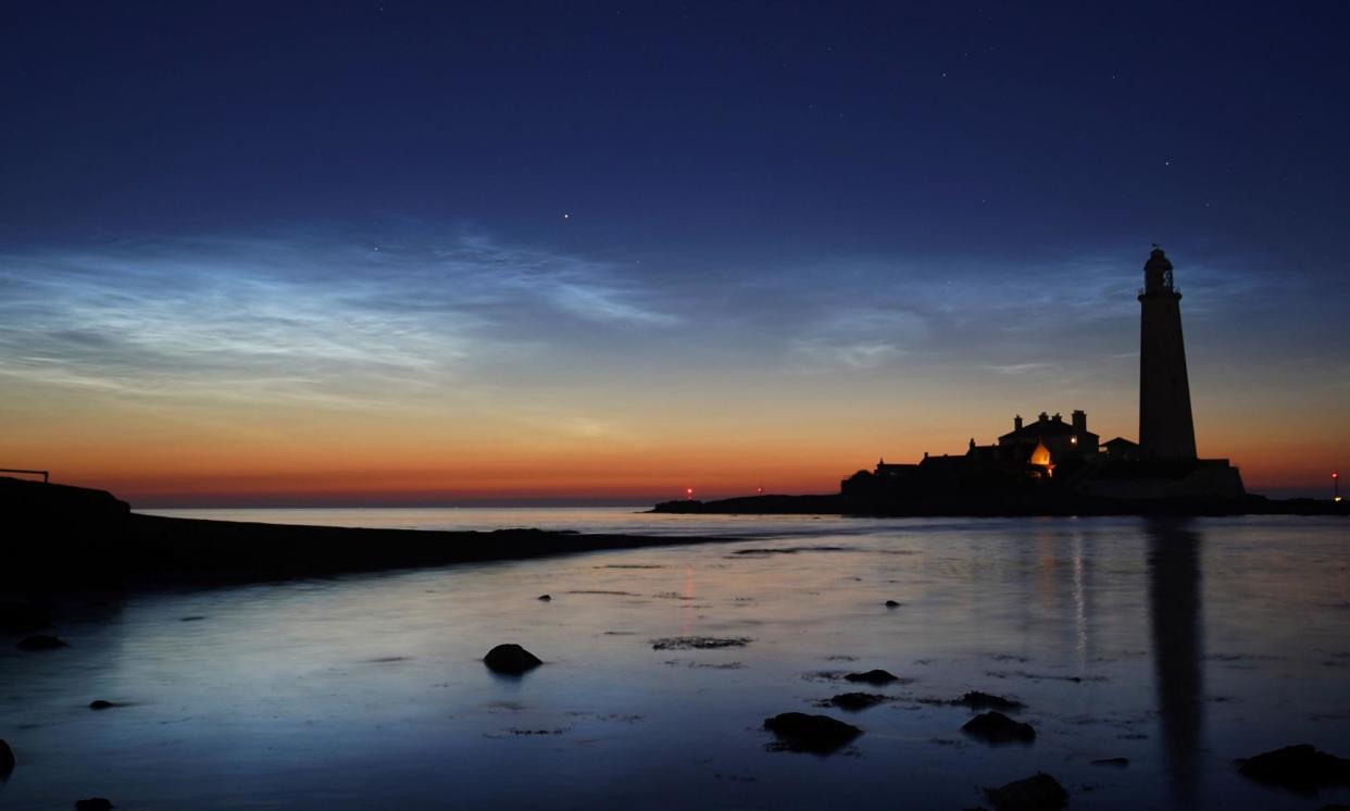 <span>Noctilucent clouds over St Mary’s lighthouse in Whitley Bay, in Tyne and Wear. The weather event is extremely rare.</span><span>Photograph: Owen Humphreys/PA</span>