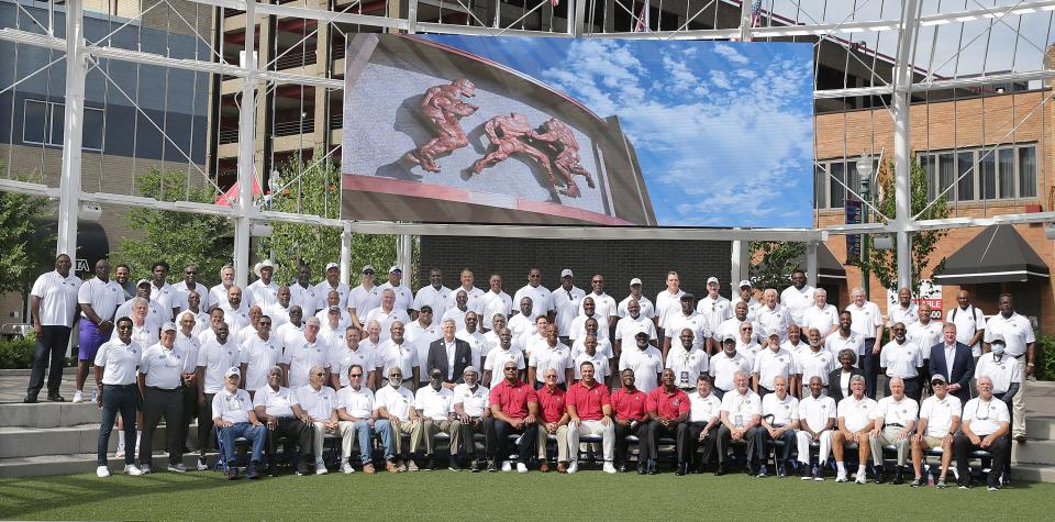 Pro Football Hall of Fame enshrinees pose for a group photo in Centennial Plaza downtown Canton Friday, August 5, 2022.