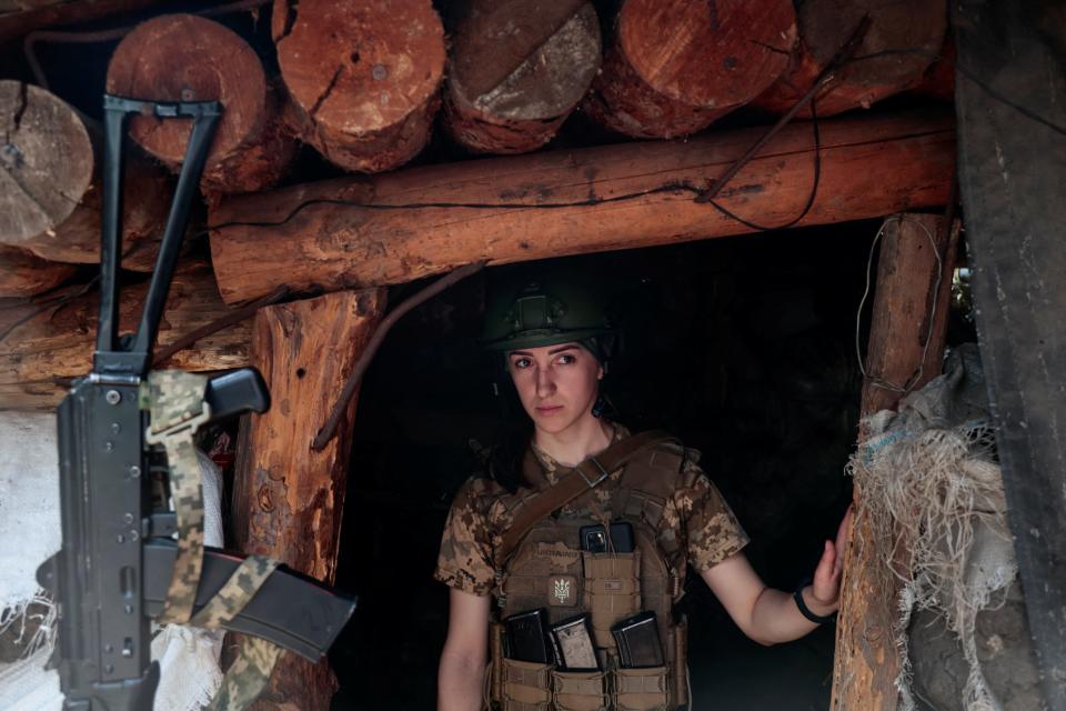 A Ukrainian soldier called Nataliia stands in a trench in Donetsk region, Ukraine, on 29 May, 2022 (REUTERS)