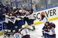 The Colorado Avalanche celebrate after the team defeated the Tampa Bay Lightning in Game 6 of the NHL hockey Stanley Cup Finals on Sunday, June 26, 2022, in Tampa, Fla. The Avalanche won 2-1. (AP Photo/John Bazemore)