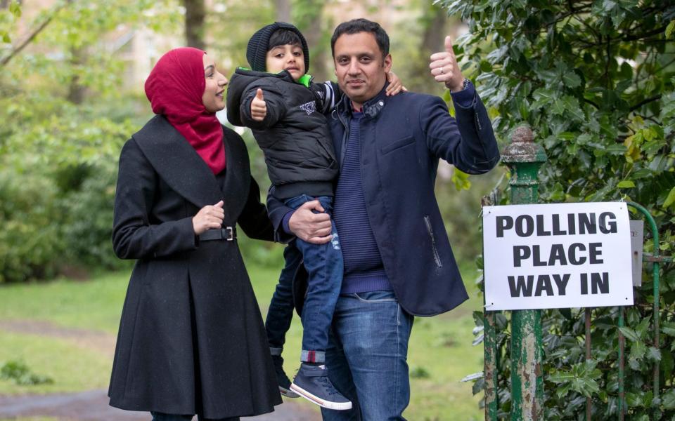 Anas Sarwar with his wife and son arrive at Pollokshields Burgh Hall in Glasgow - PA