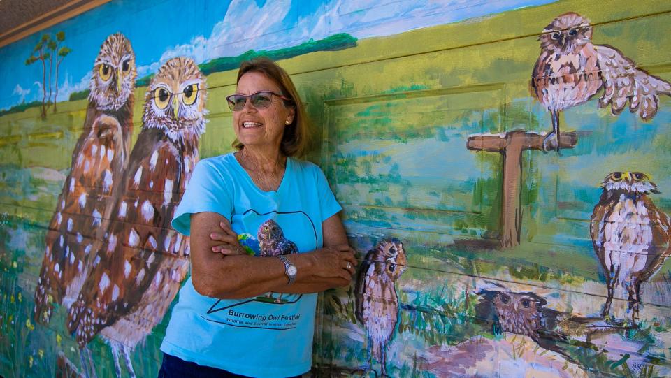 Cape Coral resident Pascha Donaldson poses for a portrait in front of her garage door mural depicting local burrowing owls Tuesday, Feb., 7, 2023. She has served as a leader in multiple roles for the Cape Coral Friends of Wildlife organization including president and vice-president among other roles. After 18 years, she will be retiring, but will continue to be active with the organization.
