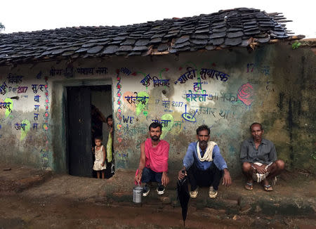 Villagers, who according to government officials will be relocated after the construction of a dam, look on as they wait to assemble for their evening meet in Daudhan village in the central state of Madhya Pradesh, August 18, 2017. REUTERS/Mayank Bhardwaj/Files