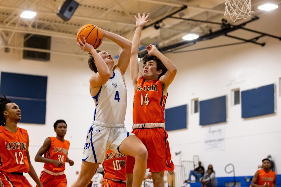 Saint Francis Catholic Wolves forward Tyler Dey (4) attempts a layup over Eastside Rams guard Ben Davis (14) during the first half at Saint Francis Catholic Academy in Gainesville, Fla., on Thursday, January 20, 2022.