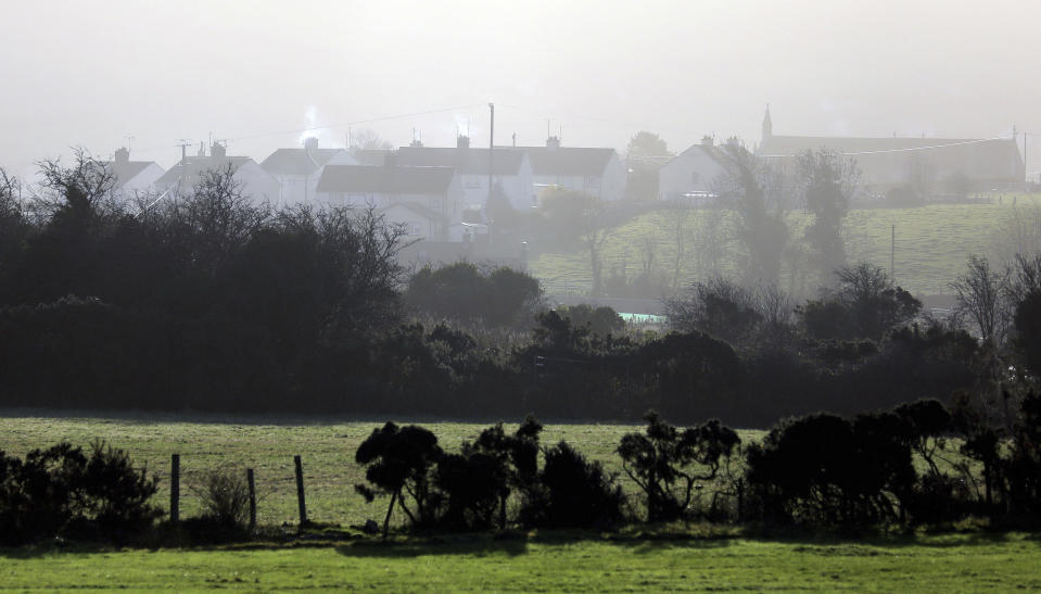 FILE - In this file photo dated Thursday, Nov. 15, 2018, a view of houses in the village of Jonesborough on the Irish border between Northern Ireland and the Irish Republic close to the town of Newry, Northern Ireland. The hope of Britain's Brexit split from the European Union depends on finding a political solution to avoid having a hard border across the peaceful green fields that span the seamless border dividing Northern Ireland from the Republic of Ireland. (AP Photo/Peter Morrison, FILE)