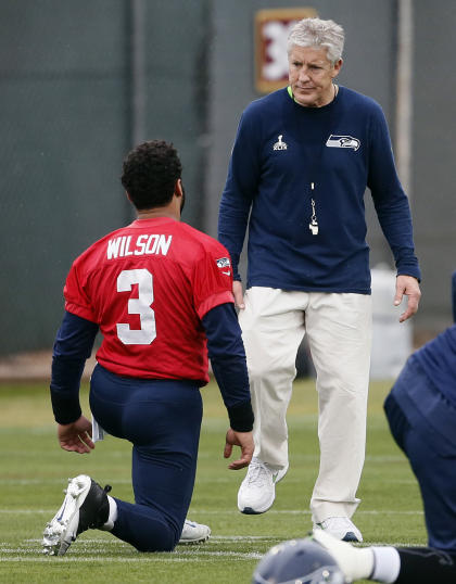 Seahawks coach Pete Carroll talks with quarterback Russell Wilson (AP)