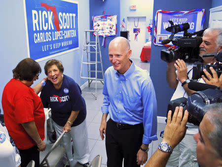 Florida Governor Rick Scott visits a campaign office in the Miami, Florida suburb of Hialeah, heart of the Cuban American community September 22, 2014. REUTERS/David Adams