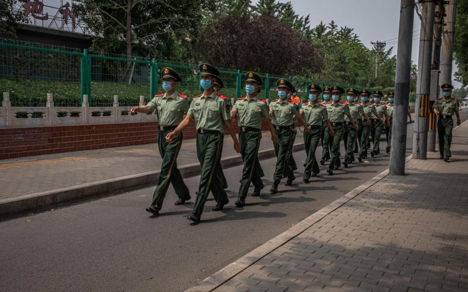 Chinese soldiers wearing face masks in Beijing - ROMAN PILIPEY/EPA-EFE/Shutterstock