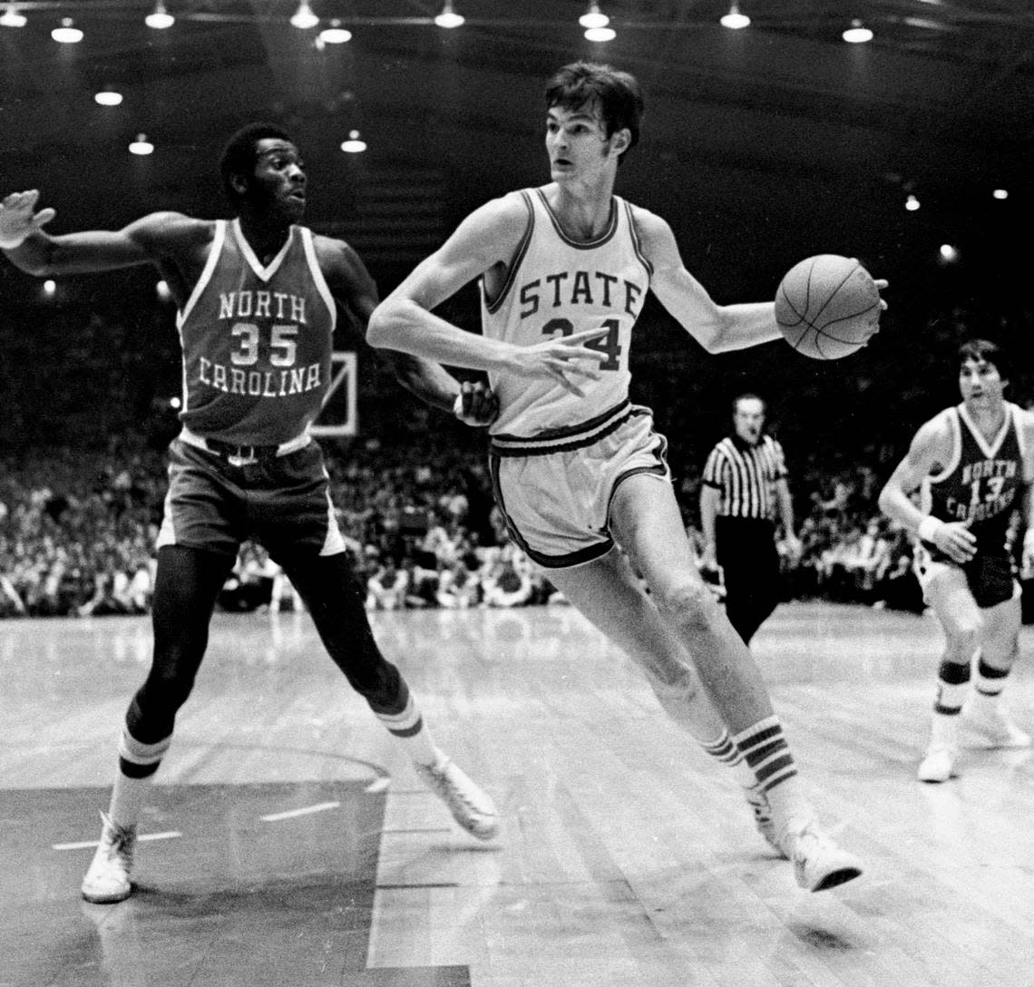 NC State’s Tommy Burleson drives to the basket against the defense of UNC’s Bob McAdoo during a game in Reynolds Coliseum in Raleigh, NC March 4, 1972.