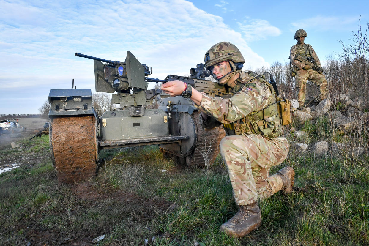 Soldiers surround a Titan Strike unmanned ground vehicle. (Photo by Ben Birchall/PA Images via Getty Images)