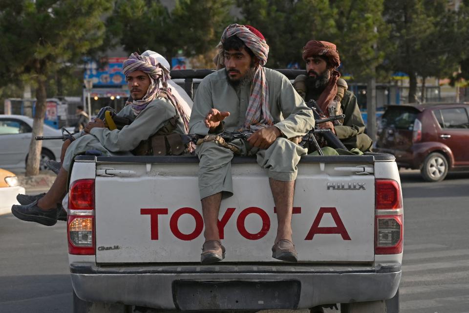 Taliban fighters in a truck patrol the streets of Kabul on Monday. The Taliban have enforced some sense of calm in a city long subject to violent crime, with their armed forces patrolling the streets and manning checkpoints. 