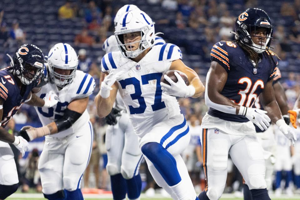 Indianapolis Colts running back Jake Funk (37) runs the ball for the go ahead touchdown while Chicago Bears safety Kendall Williamson (36) defends.