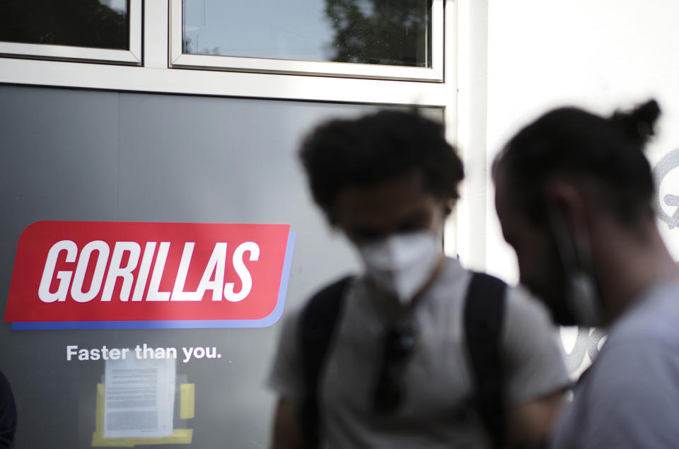 Workers block the entrance of a depot for German startup Gorillas, a grocery delivery company, to protest the firing of a colleague in Berlin, Germany, Thursday, June 10, 2021. The company Gorillas operates in dozens of cities across Germany, France, Italy, the Netherlands and Britain, and has already set its sights on New York. (AP Photo/Markus Schreiber)