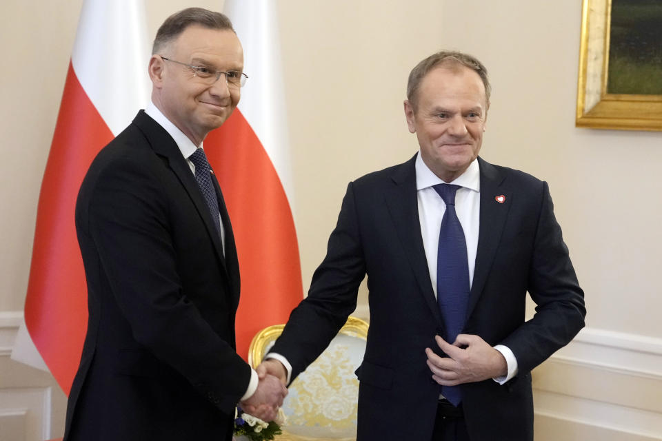 Poland's President Andrzej Duda, left, who is allied with the right-wing opposition, and new pro-European Union Prime Minister Donald Tusk shake hands before talks on Poland's security and continuing support for neighbouring Ukraine, at the Presidential Palace in Warsaw, Poland, Monday Jan. 15, 2024. Tusk is to travel to Kyiv in the coming days at the invitation of Ukraine President Volodymyr Zelenskyy. (AP Photo/Czarek Sokolowski)