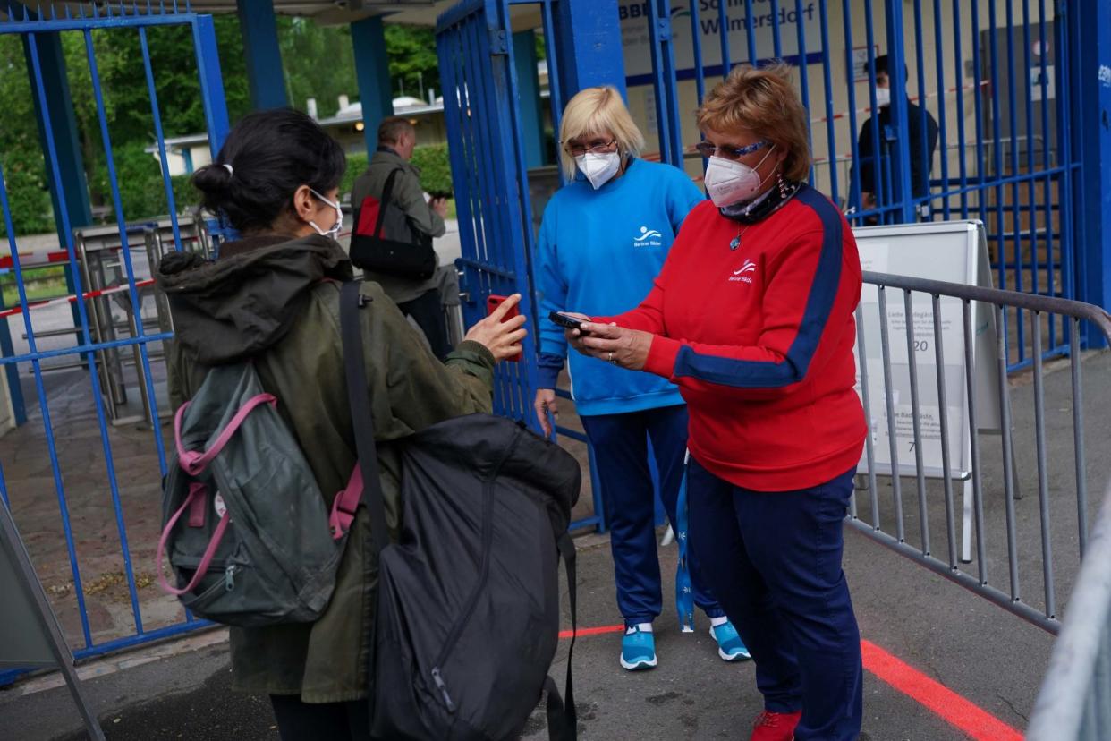 Back in the swim: staff check timed tickets as German public pools reopen: Getty Images