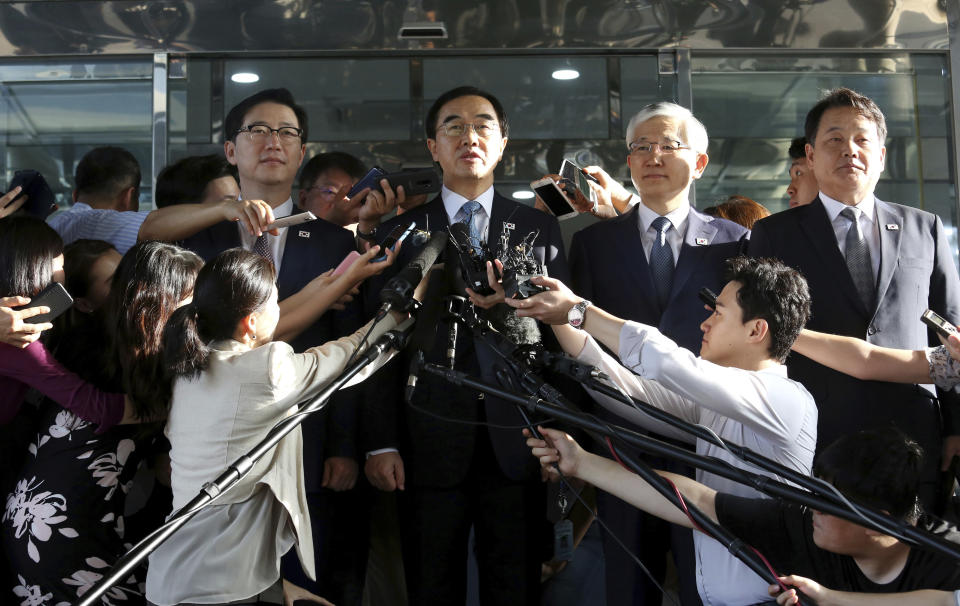 South Korean Unification Minister Cho Myoung-gyon, center, speaks to the media before leaving for the border village of Panmunjom to attend a meeting between South and North Korea, at the Office of the South Korea-North Korea Dialogue in Seoul, South Korea, Monday, Aug. 13, 2018. (AP Photo/Ahn Young-joon)