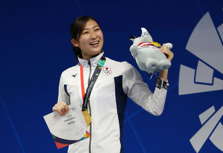 FILE PHOTO: Swimming - 2018 Asian Games - Women's 50m Freestyle - GBK Aquatic Center, Jakarta, Indonesia - August 24, 2018 Japan's Rikako Ikee celebrates with her medal after winning the Women's 50m Freestyle REUTERS/Athit Perawongmetha/File Photo