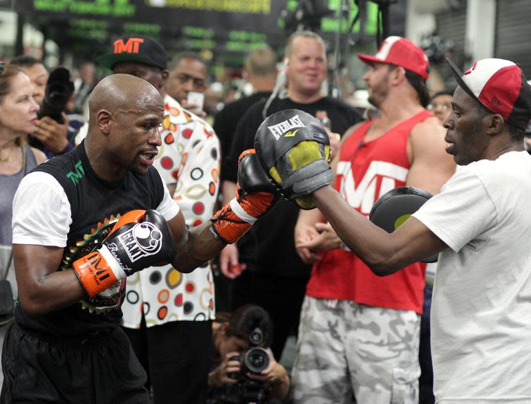 Floyd Mayweather Jr. (left) works out with his uncle Roger Mayweather at the Mayweather Boxing Club in las Vegas, on April 14, 2015