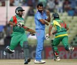 Bangladesh's Shamsur Rahman (L) and Anamul Haque run between the wickets as India's bowler Mohammed Shami (C) watches during their Asia Cup 2014 one-day international (ODI) cricket match in Fatullah February 26, 2014.