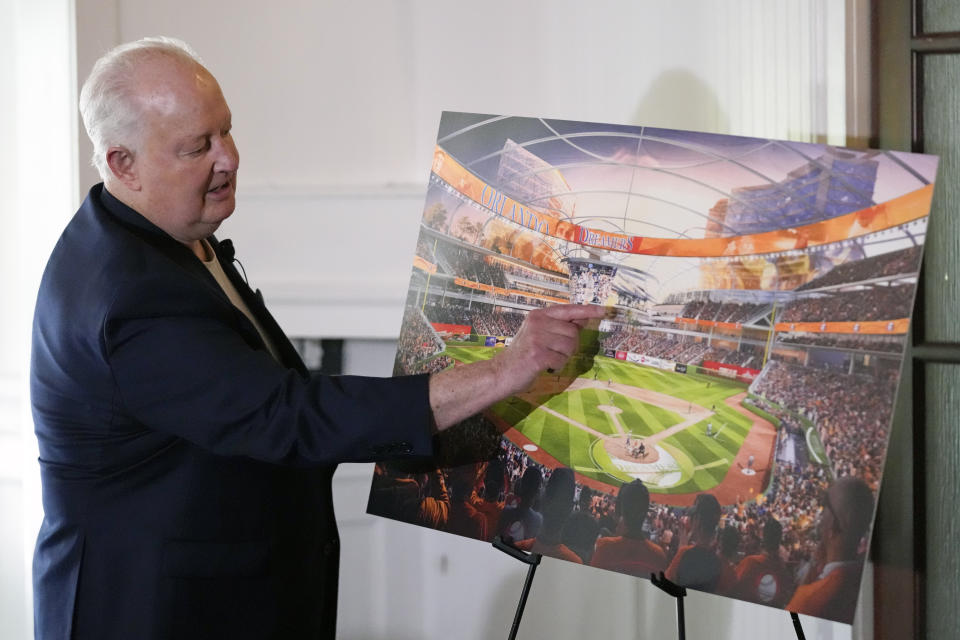 Former Orlando Magic basketball executive Pat Williams unveils renderings, at a news conference, of a proposed domed stadium that he hopes will bring an MLB baseball team to Central Florida, Tuesday, May 9, 2023, in Orlando, Fla. (AP Photo/John Raoux)